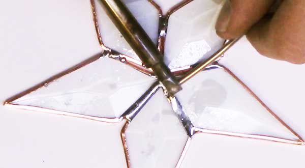 A demonstration of soldering a glass art project.